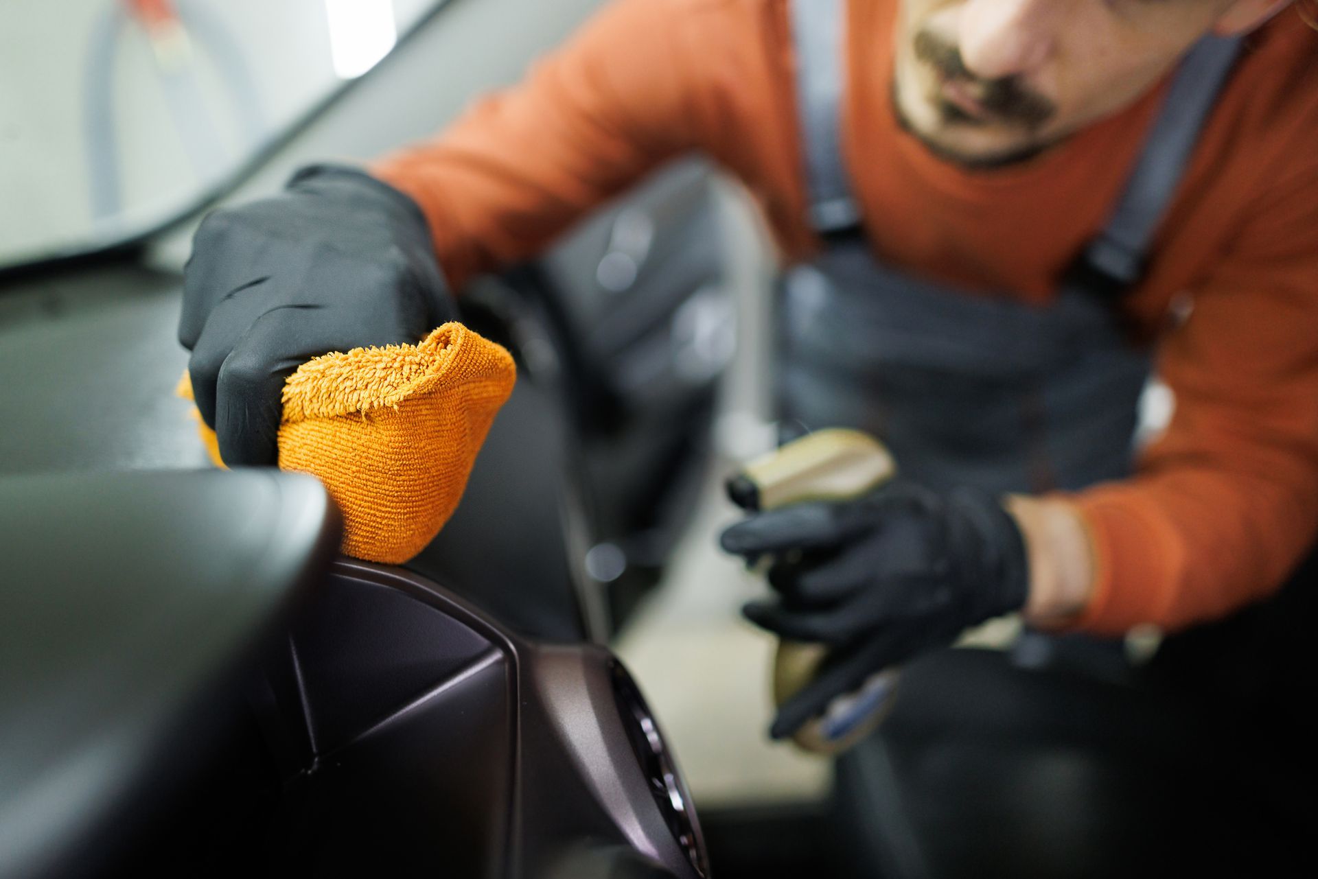 Professional Car Detailer Cleaning Car Interior With A Microfiber Towel - San Pablo, CA - Grand Prix Car Wash San Pablo
