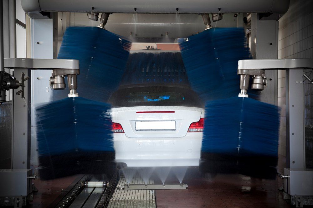 A White Car Is Being Washed In A Car Wash - San Pablo, CA - Grand Prix Car Wash San Pablo