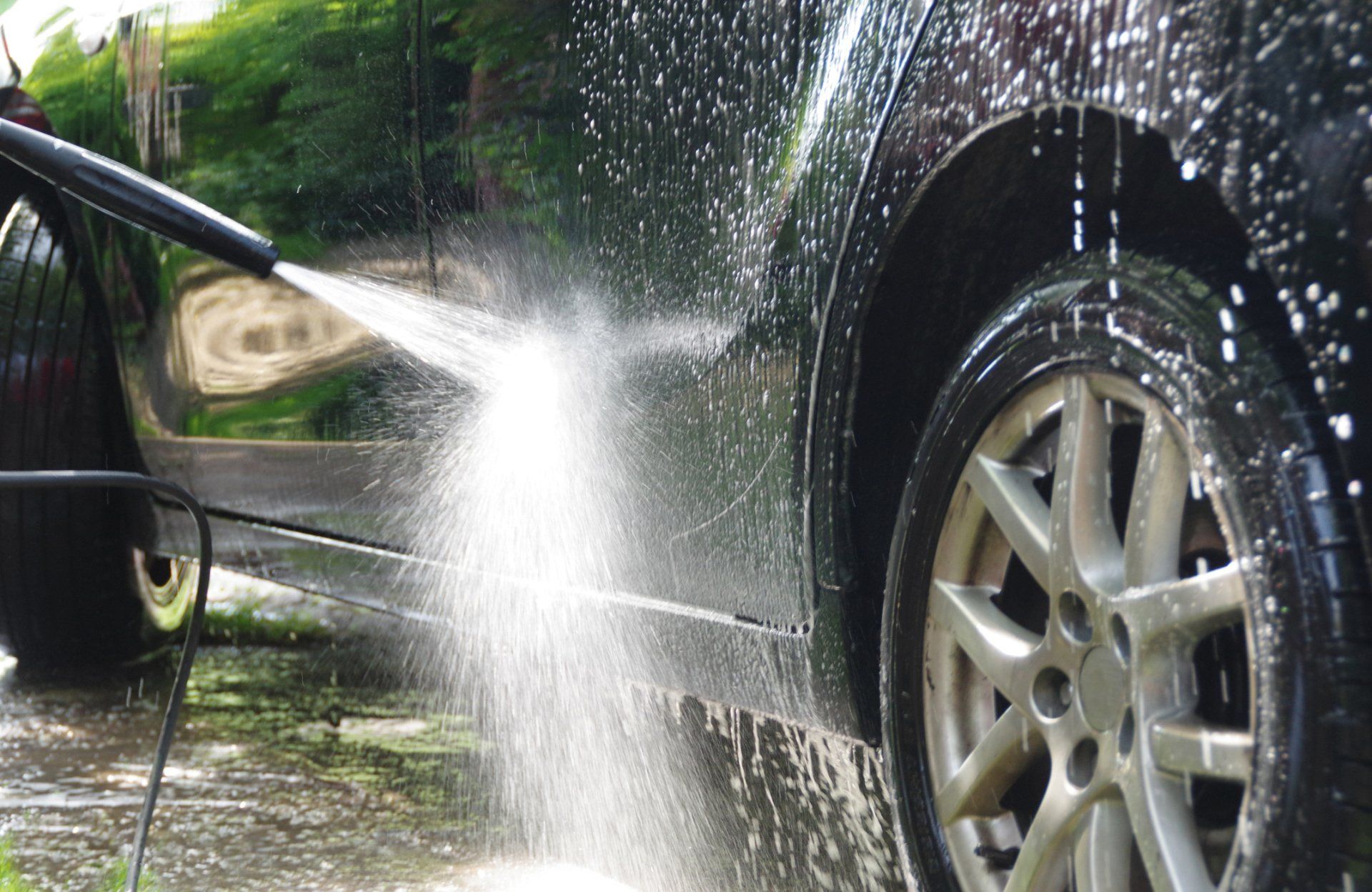 A Person Is Washing A Car With A High Pressure Washer - San Pablo, CA - Grand Prix Car Wash San Pablo