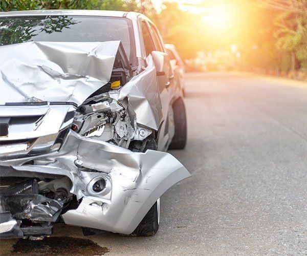 A Silver Car With A Damaged Front End Is Parked On The Side Of The Road - San Pablo, CA - Grand Prix Car Wash San Pablo