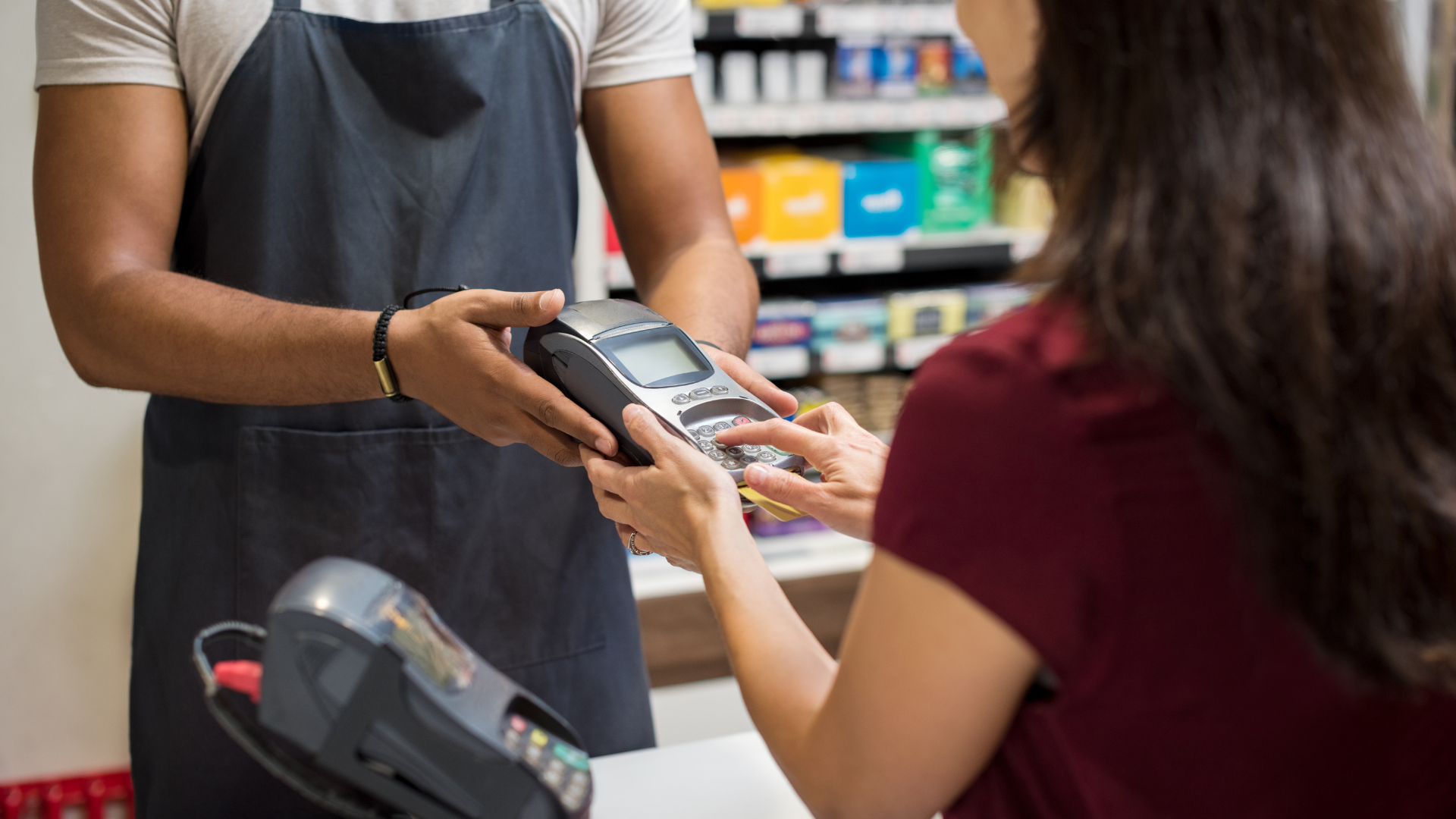 A woman is paying with a credit card in a store.