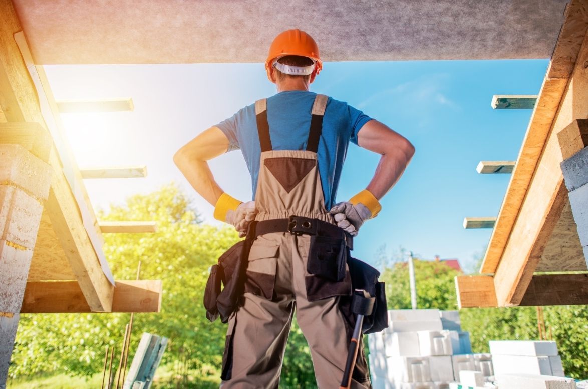 A construction worker is standing on a construction site