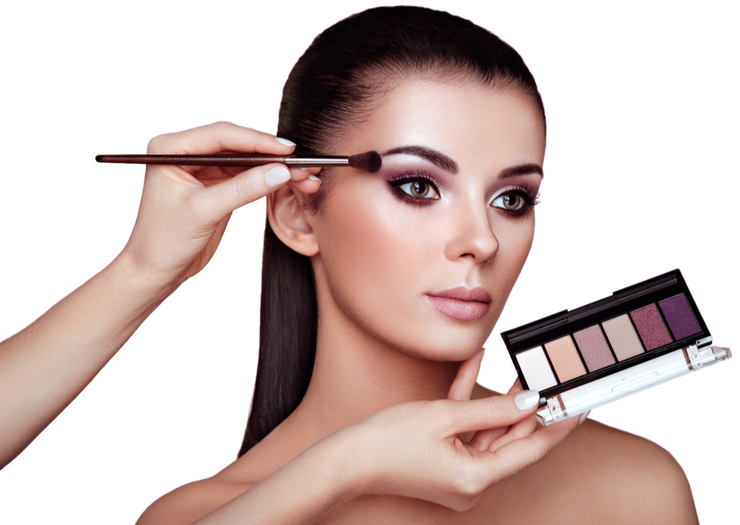 A woman is getting her makeup done by a makeup artist.