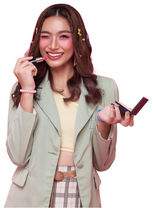 A woman in a green jacket is applying lipstick to her lips