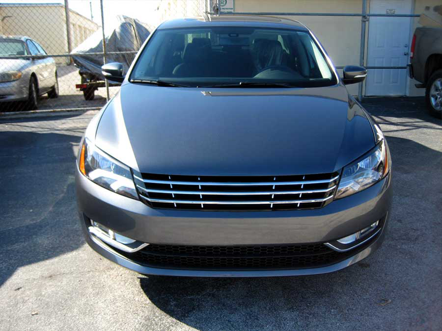 A gray car is parked in front of a building | B & R Auto Body Works