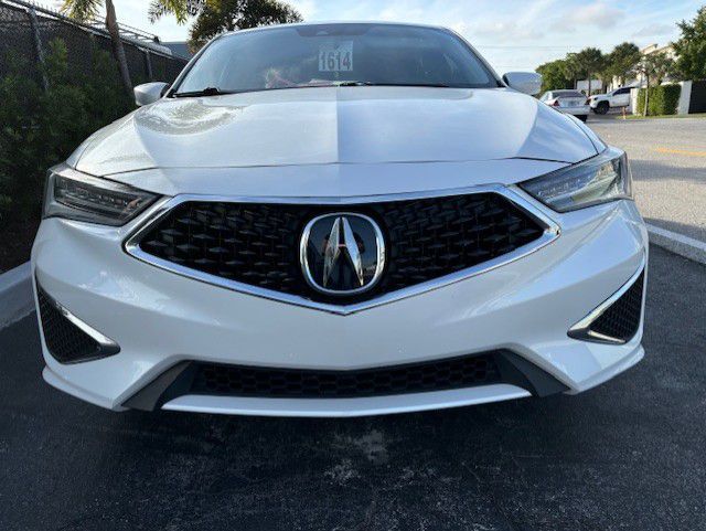A white Acura 20 ILX parked in a parking lot | B & R Auto Body Works