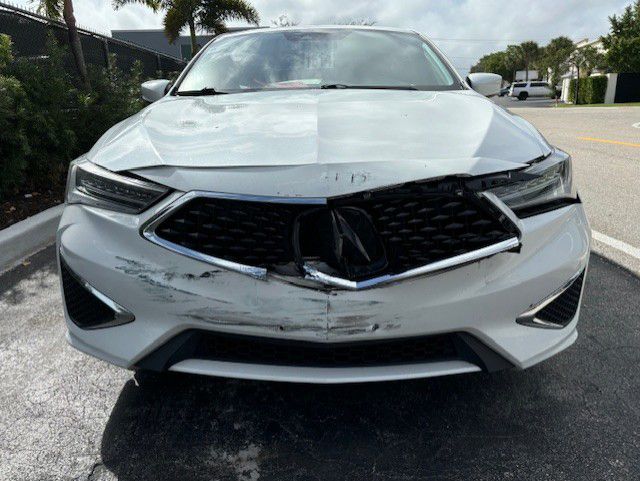 A damaged white Acura 20 ILX parked in a parking lot | B & R Auto Body Works