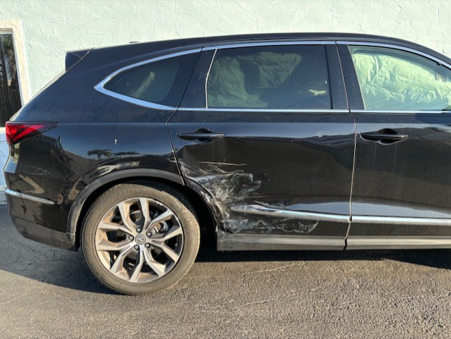 A damaged black Acura 24 MDX parked in a parking lot | B & R Auto Body Works