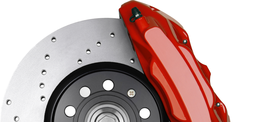 Red brake caliper on a silver disc brake rotor with holes | Jeff's Automotive, Inc