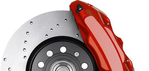Red brake caliper on a silver disc brake rotor with holes | Jeff's Automotive, Inc