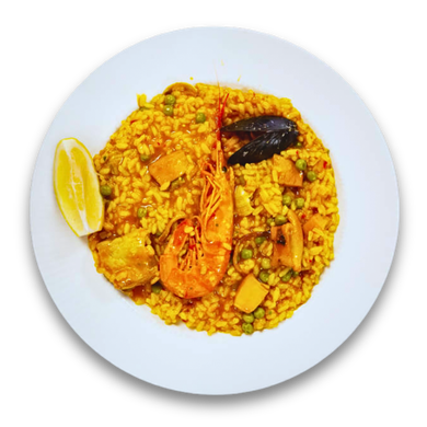 Paella with shrimp, mussels, peas, and a lemon wedge on a white plate.