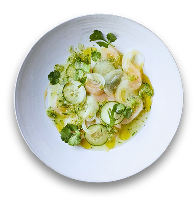 Plate of ceviche with thinly sliced fish, cucumber, onion, and herbs.