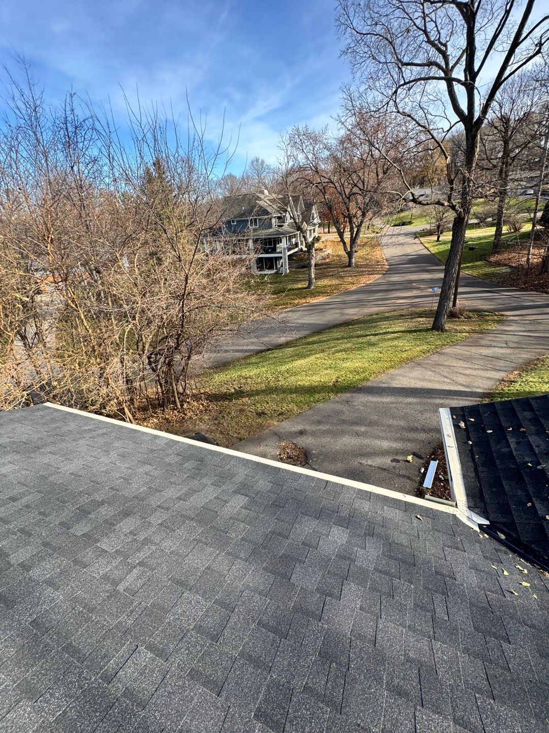 Hallway with blue paneled walls, doors, and skylights in the ceiling.