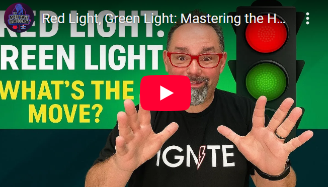 A man is standing in front of a red light and green light