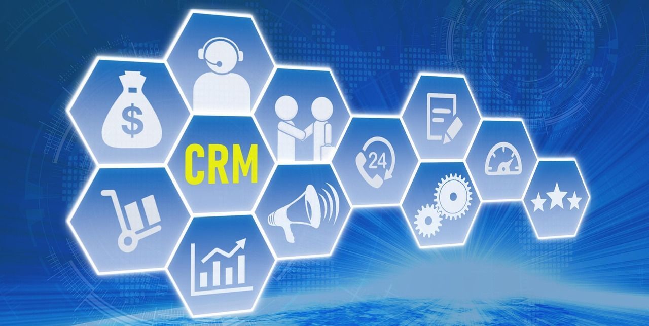 Blue graphic with interconnected hexagon icons representing CRM concepts.