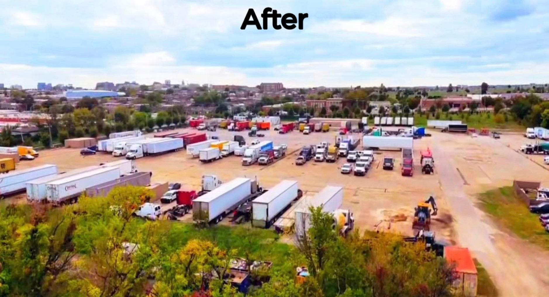 Aerial view of a truck yard filled with semi-trucks, trailers, and other vehicles