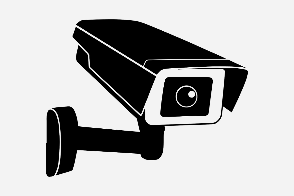 Black security camera mounted on a wall bracket.
