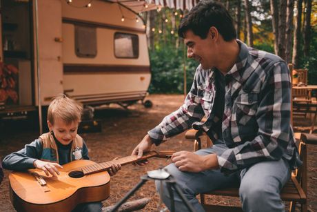 Father Teaches His Son Play Guitar — Vinton, IA — Three Rivers Insurance LLC