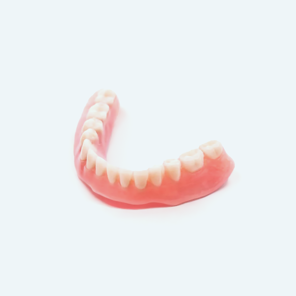 Set of upper dentures, pink gums, white teeth, isolated on a white background.
