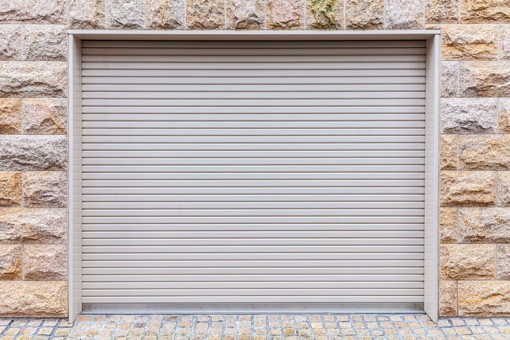 Black horizontal slat gate partially open, revealing a car in a driveway.