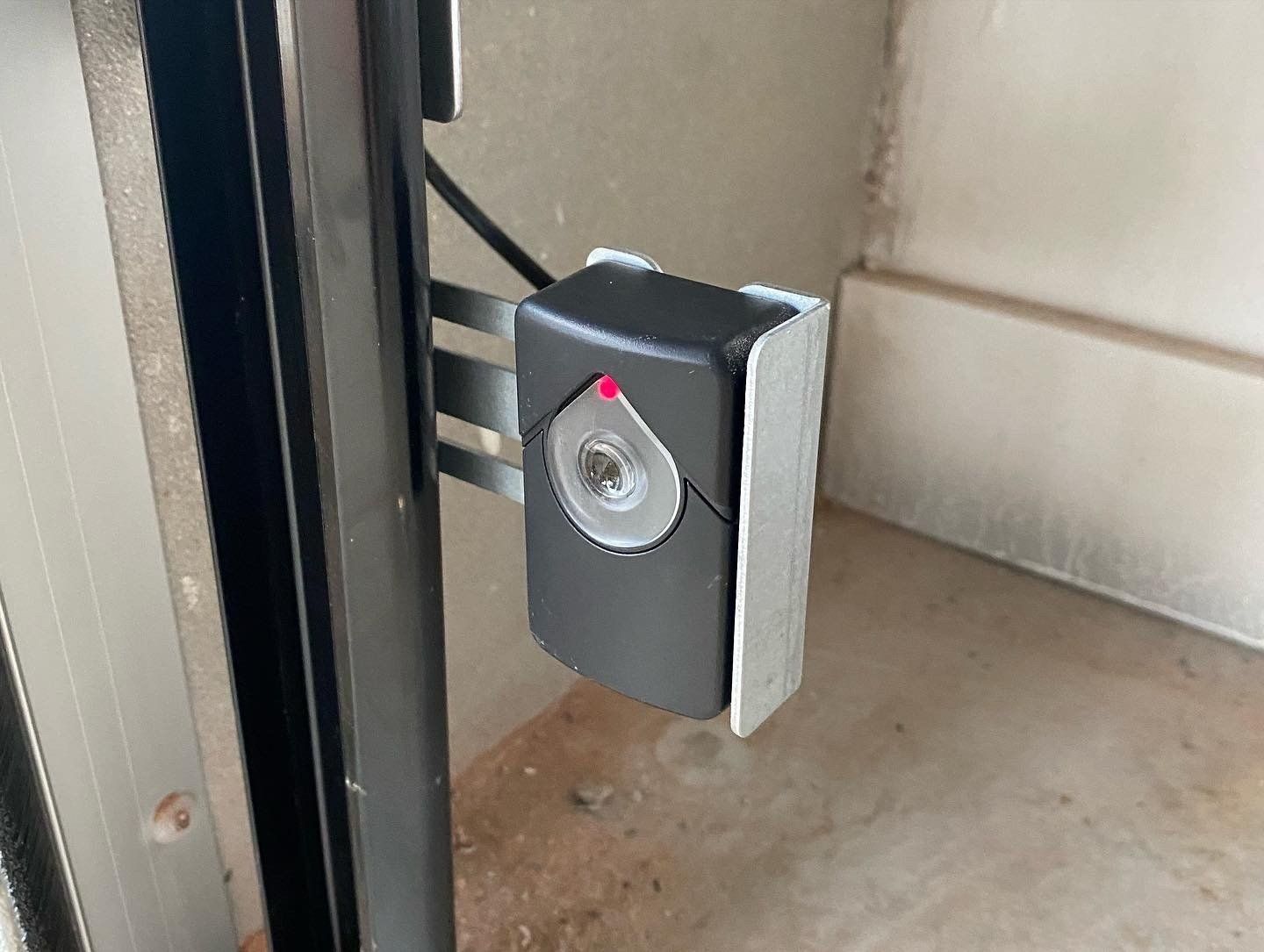 Brown garage doors with concrete ramps leading from the driveway. Orange and tan stone accents.