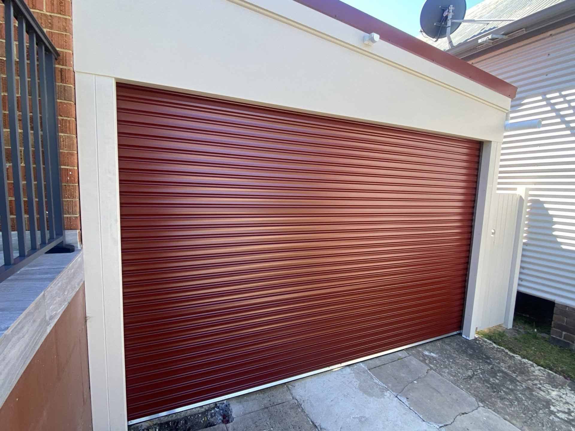 Red rolling garage door in a white frame.