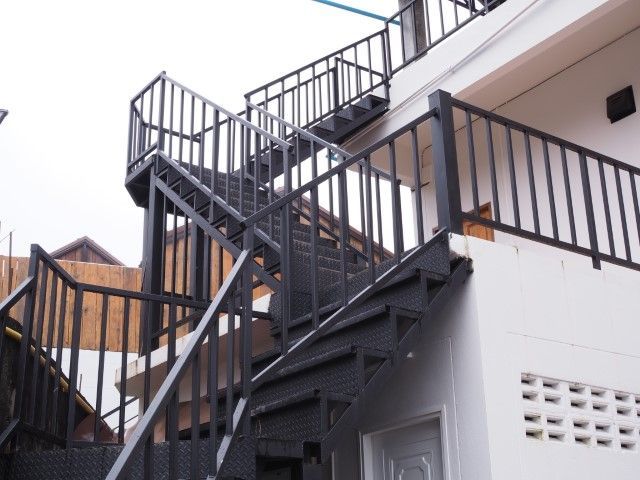 Black steel dog-leg staircase at hotel entrance in Haysville, KS