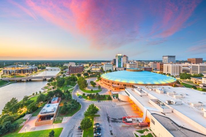Aerial view of Wichita, Kansas, downtown at sunset with pink and blue sky.