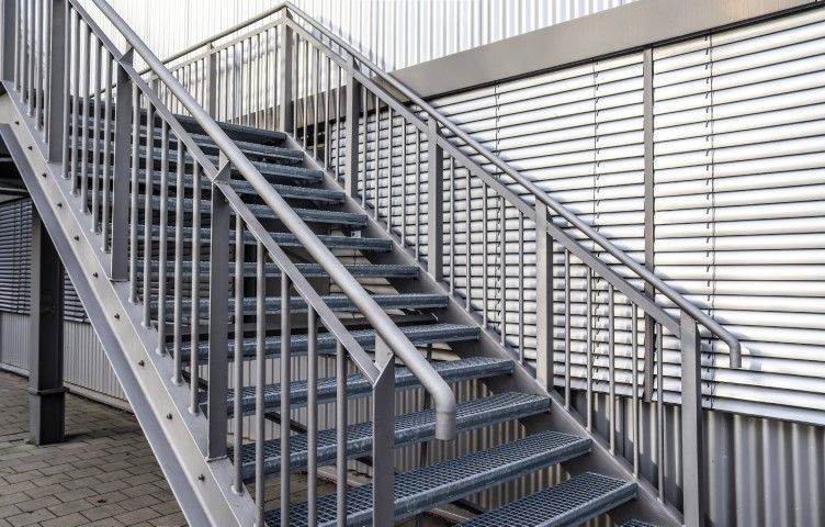 Exterior metal staircase beside a metal-sided building