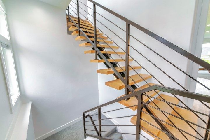 Floating staircase with metal and wood elements in Andover, KS residential property