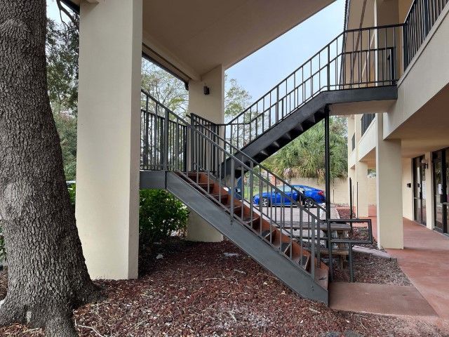 Two-level structure in Rose Hill, KS featuring outdoor winding staircase.