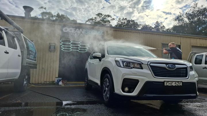 White Subaru Being Washed at an Outdoor Car Wash — Ocean Glow Mobile Detailing in Gorokan, NSW