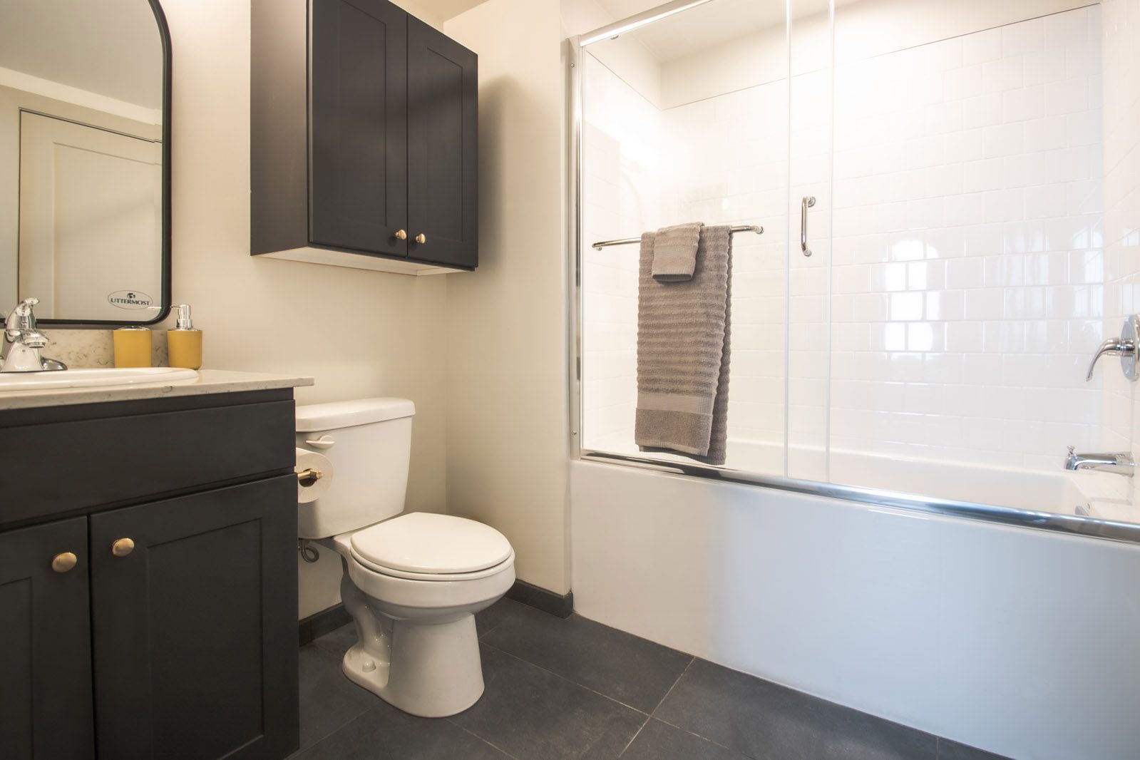 A bathroom with a toilet , sink , and bathtub.