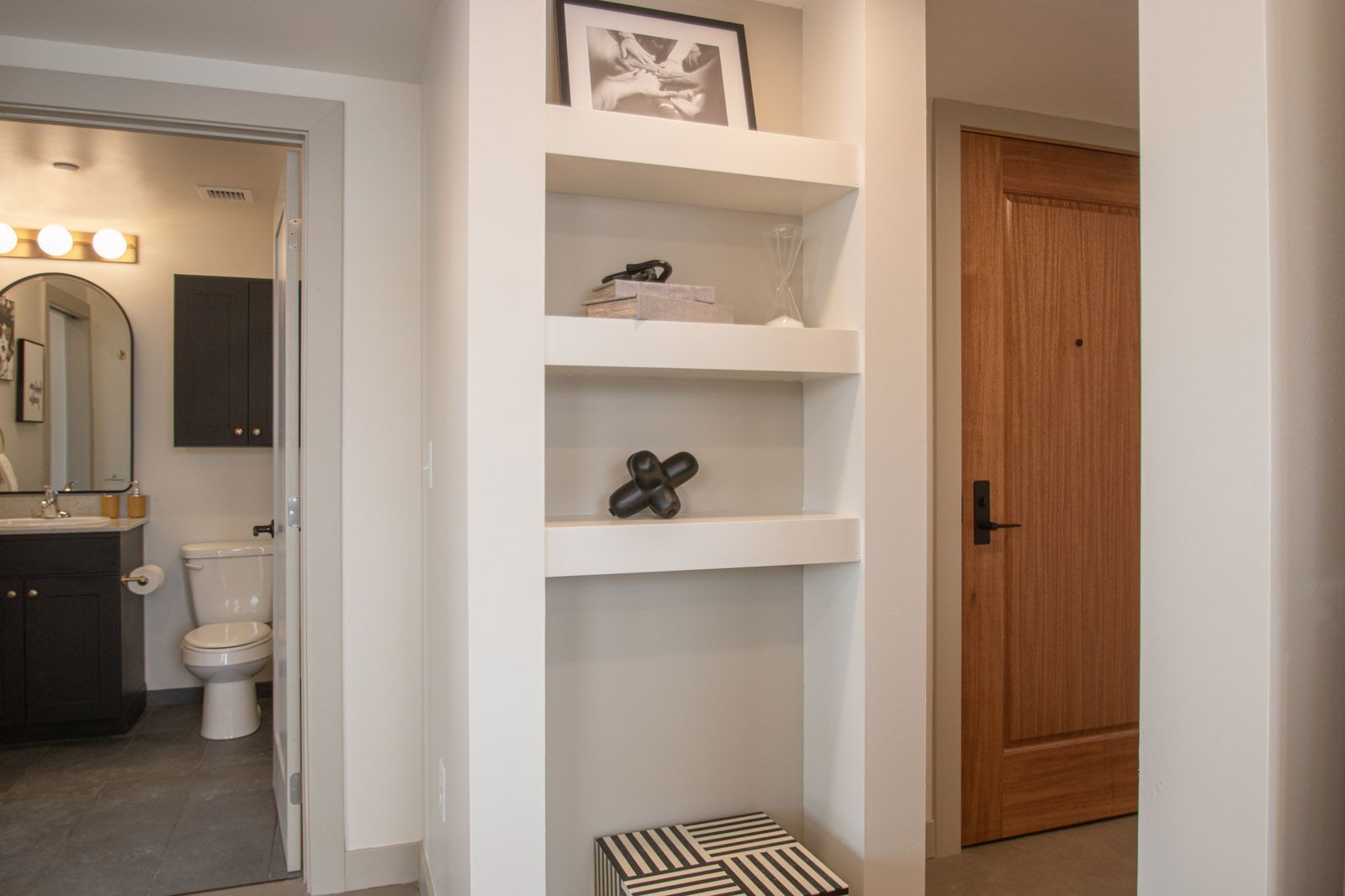 A bathroom with a toilet , sink and mirror