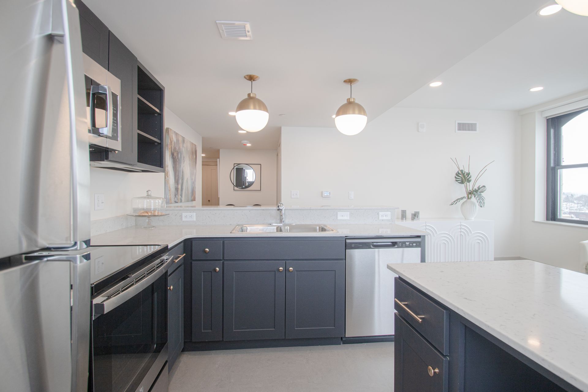 Dog-Friendly Luxury Apartments in Sioux City, IA - Badgerow Flats - Kitchen with a Spacious Island, Modern Appliances, and a Breakfast Bar