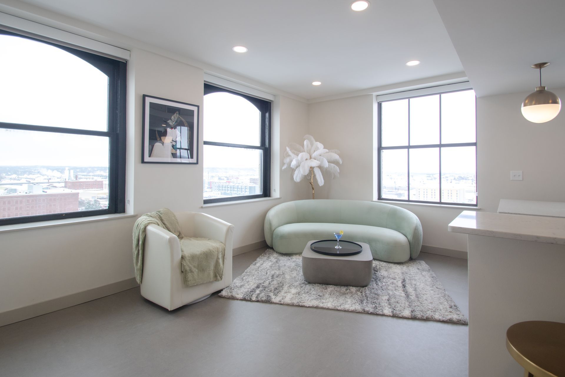 A living room with a couch a chair and a coffee table