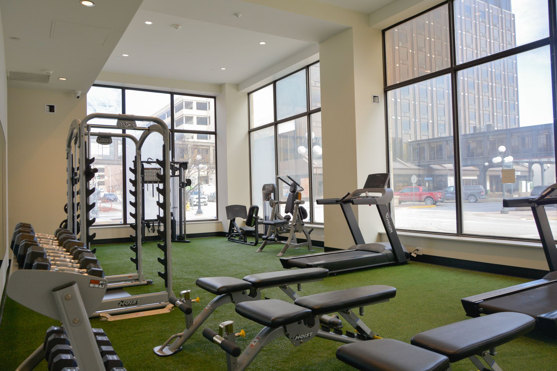 Pet-Friendly Luxury Apartments in Sioux City, IA - Fitness Center with Floor-to-Ceiling Windows, Free Standing Weights, and Modern Machines