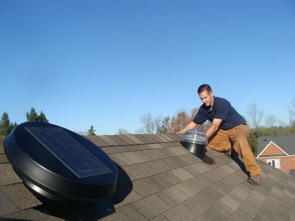 Picture of John Hewit Solatube Installer on a roof performing a skylight solar panel install