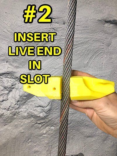 A person is holding a yellow object that says insert live end in slot.
