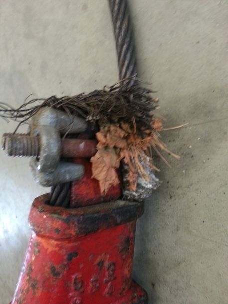 A close up of a broken rope on a red object