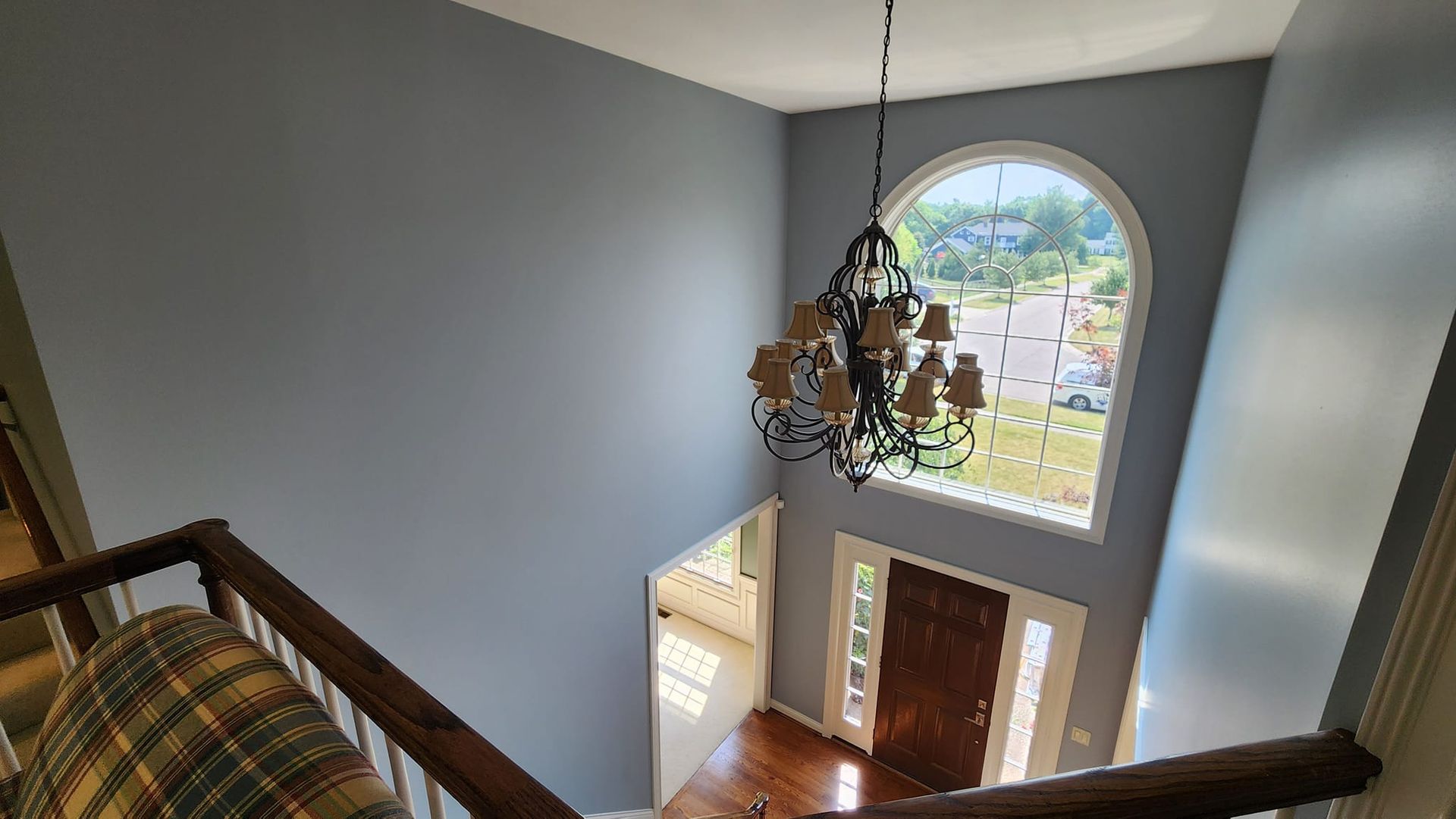 An aerial view of a house with a chandelier hanging from the ceiling.