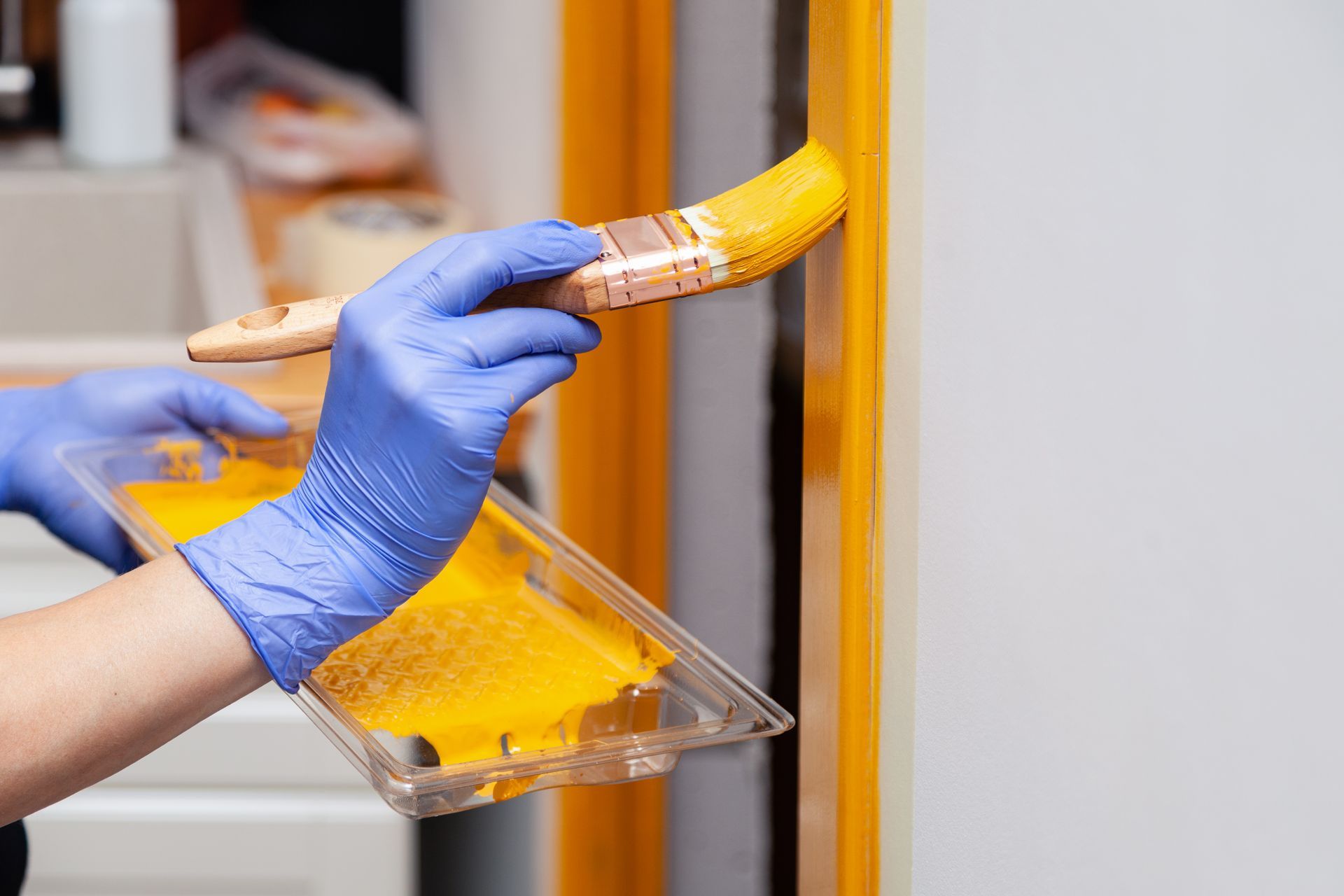A person is painting a door with a brush.
