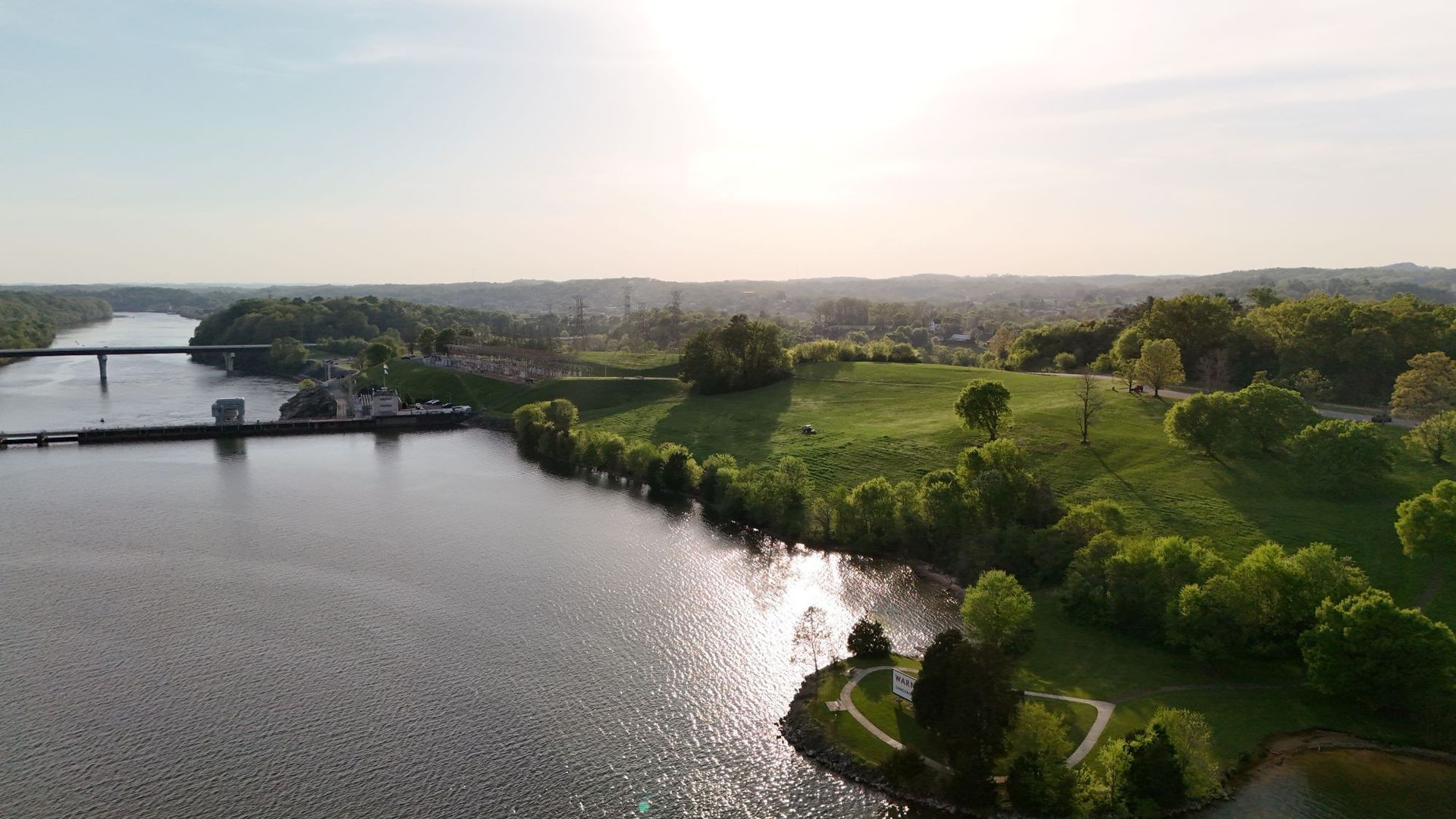 An aerial view of Fort Loudoun Lake surrounded by trees and a bridge.