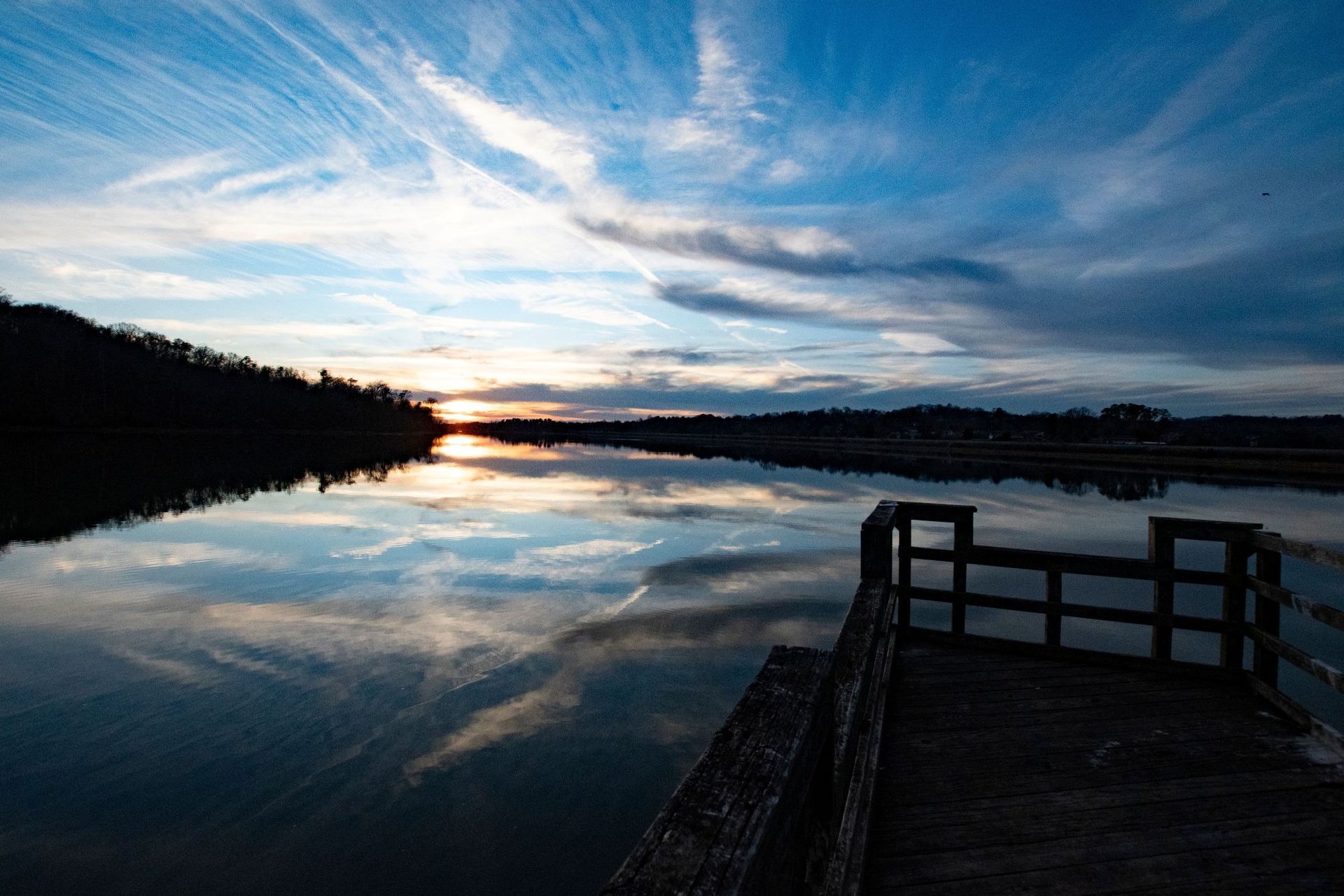 A sunset over Fort Loudoun Lake with a dock in the foreground