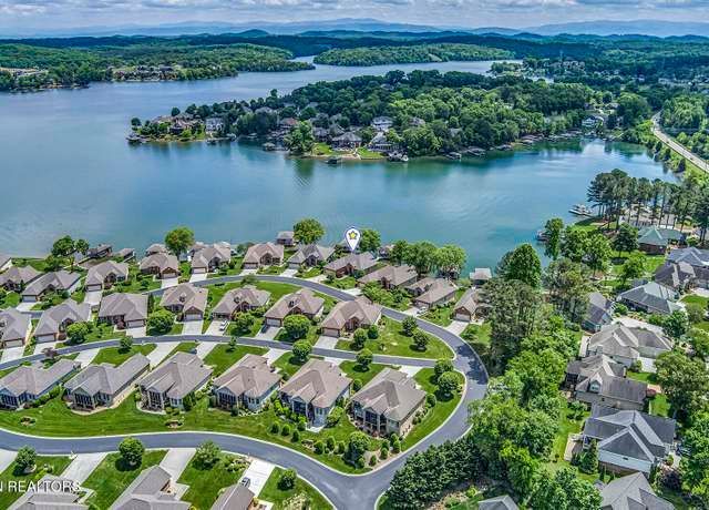 An aerial view of a residential area next to a lake.