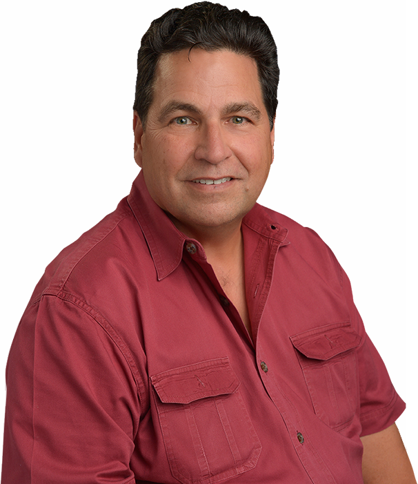 A man in a red shirt is smiling for the camera