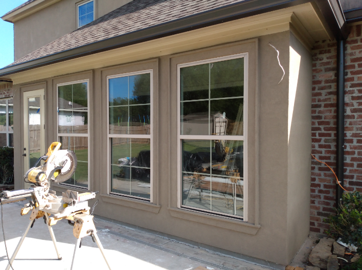 A house with a lot of windows and a saw on the side of it