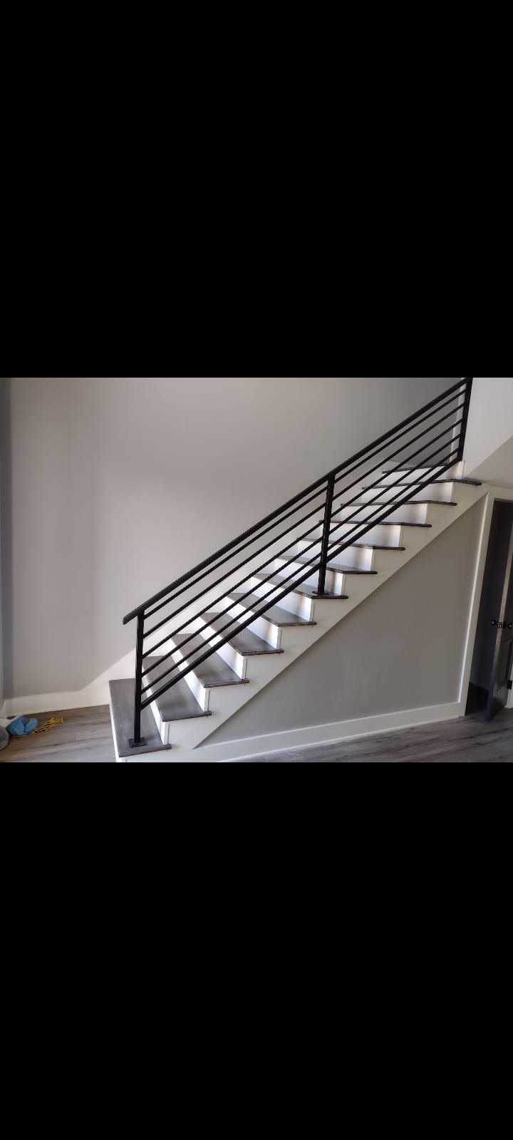 A staircase with a metal railing in a house.
