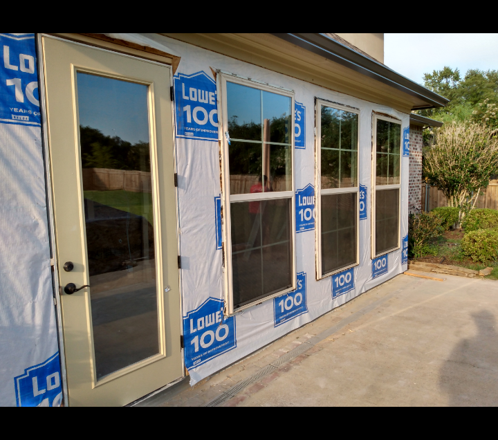 A house with a lot of windows and doors is being built
