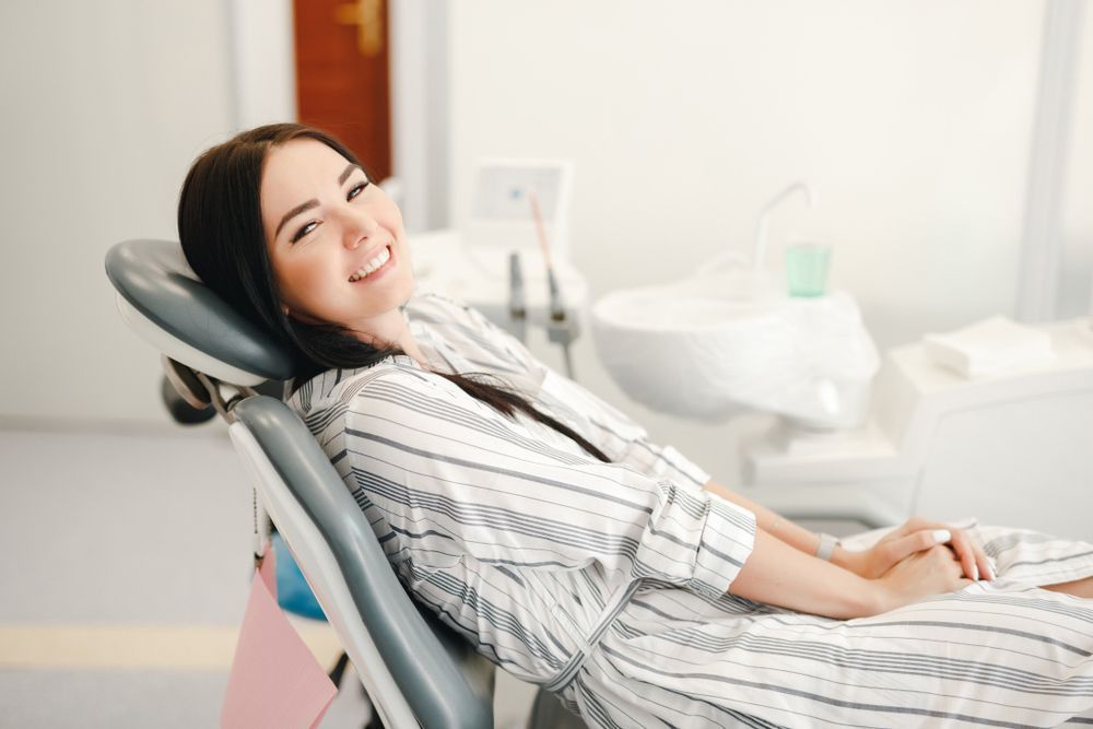 Smiling and Satisfied Patient in a Dental Office After Treatment — Dental Clinic in Alexandra Headland, QLD